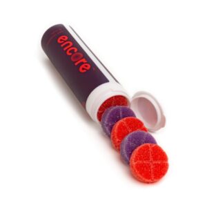 An image of Encore Edibles 600mg THC Wild Fruit & Strawberries Gummies in their tube packaging with some stacked in front of it to showcase the gummies