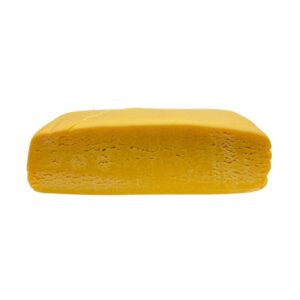 An image of Blueberry Kush Hash Rosin cut in half to showcase the inside of the product on a white background