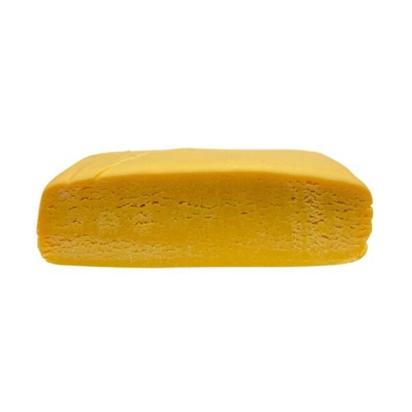 An image of Blueberry Kush Hash Rosin cut in half to showcase the inside of the product on a white background