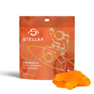 An image of Stellar Creamsicle Gummies showcasing the gummies next to the orange packaging on a white background