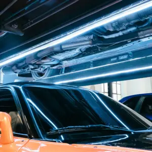 LED lift lights illuminating the underside of a car on a four post lift